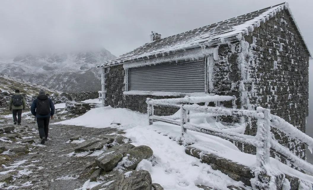 The same kind of low stone summit building shut and rimed with ice in winter, snow banked against its walls.