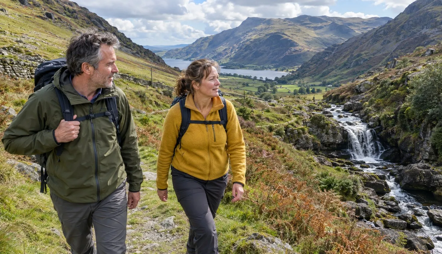 Two walkers on the Watkin Path beside the waterfalls in Cwm Llan