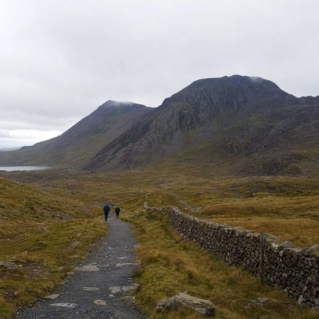 two distant walkers small on a broad ridge path